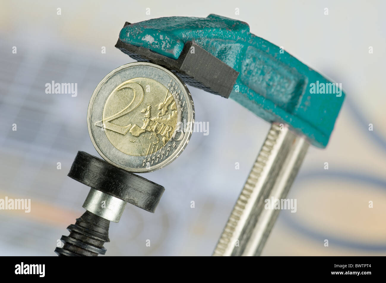 Euro coin in clamp Stock Photo