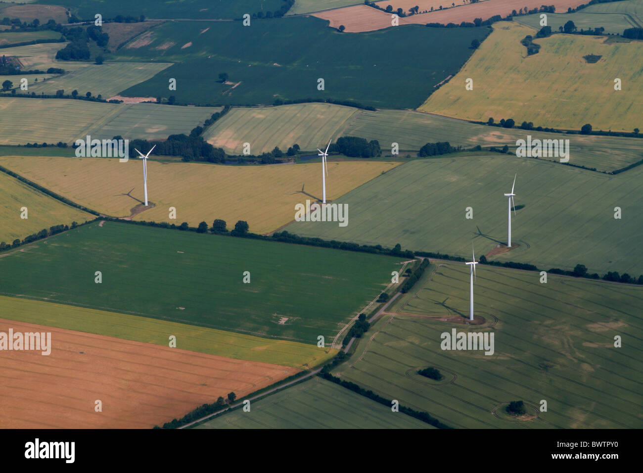 Aerial picture of  wind power stations standing on different agriculture fields Stock Photo