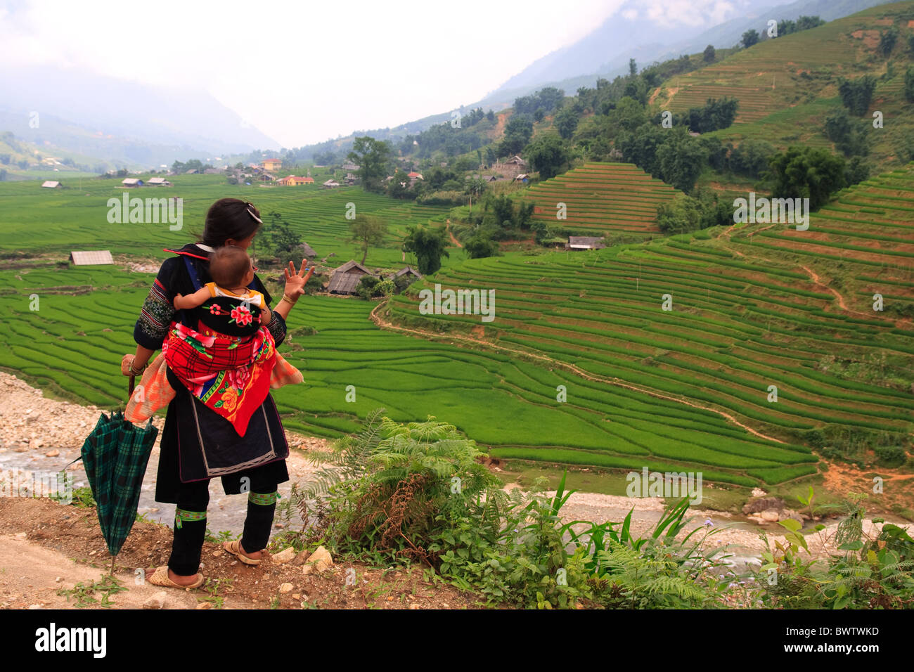 Traditionally dressed Sapa Highlands women entertains baby, Vietnam, Asia Stock Photo