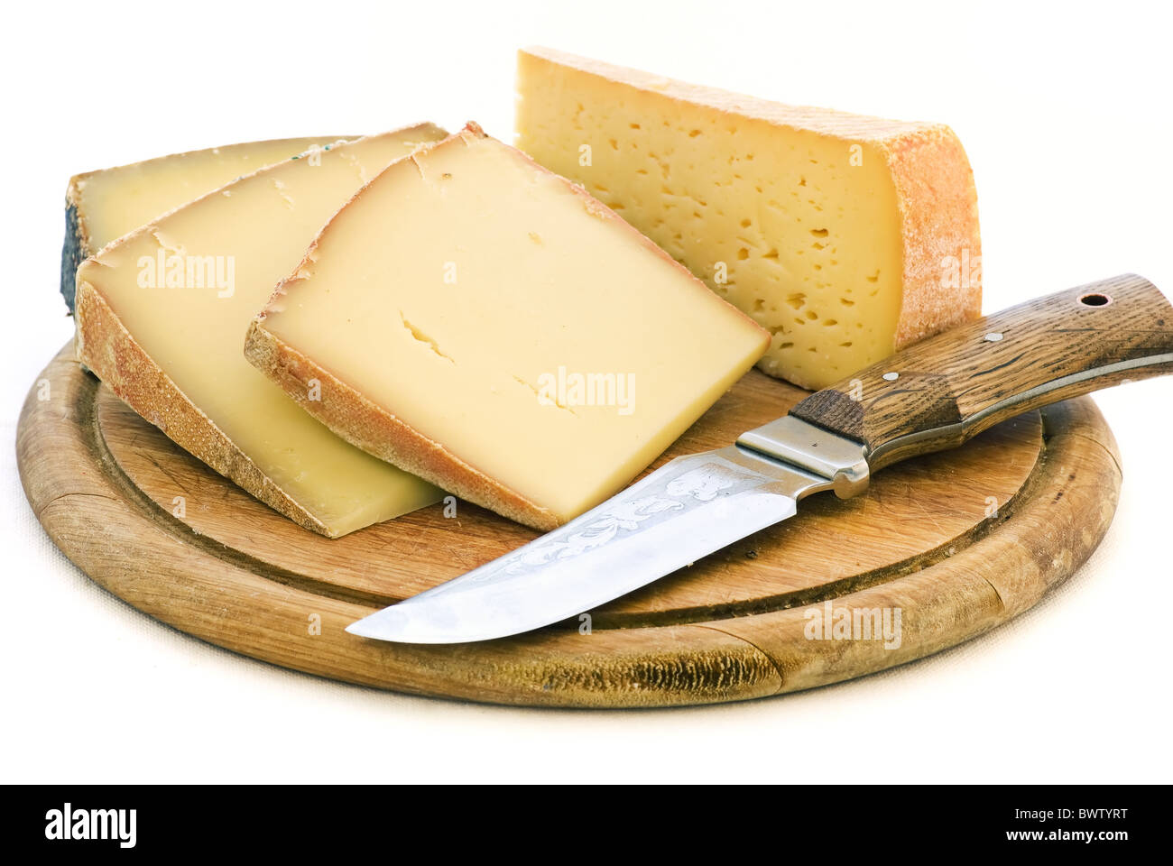 Mountain cheese collection with knife as closeup on a chopping board Stock Photo