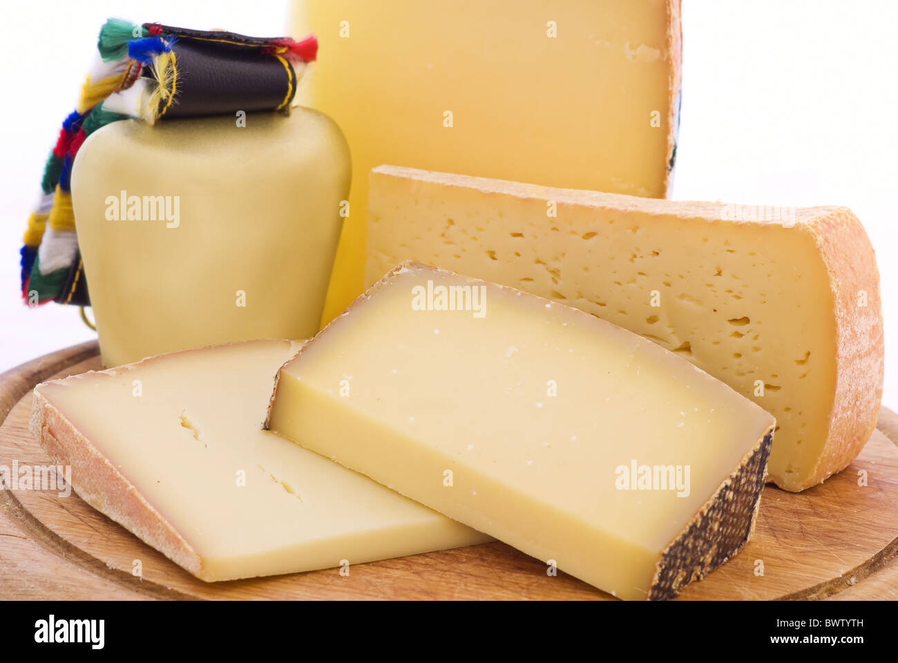 Mountain cheese colletion with cowbell as closeup on a chopping board Stock Photo