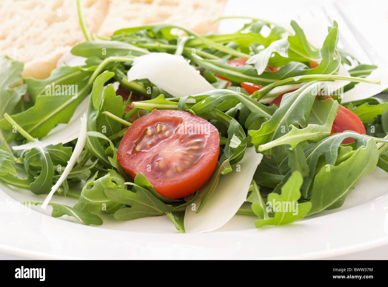 Rocket salad with tomato and pecorino as closeup Stock Photo