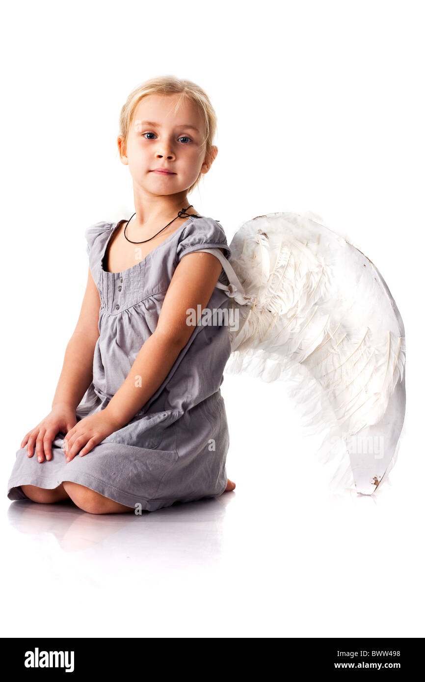 Beautiful girl with angel wings sitting isolated on white Stock Photo ...