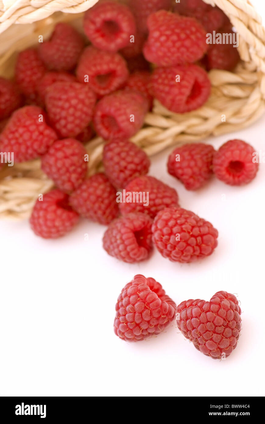 Fresh raspberry in and outside of a basket Stock Photo