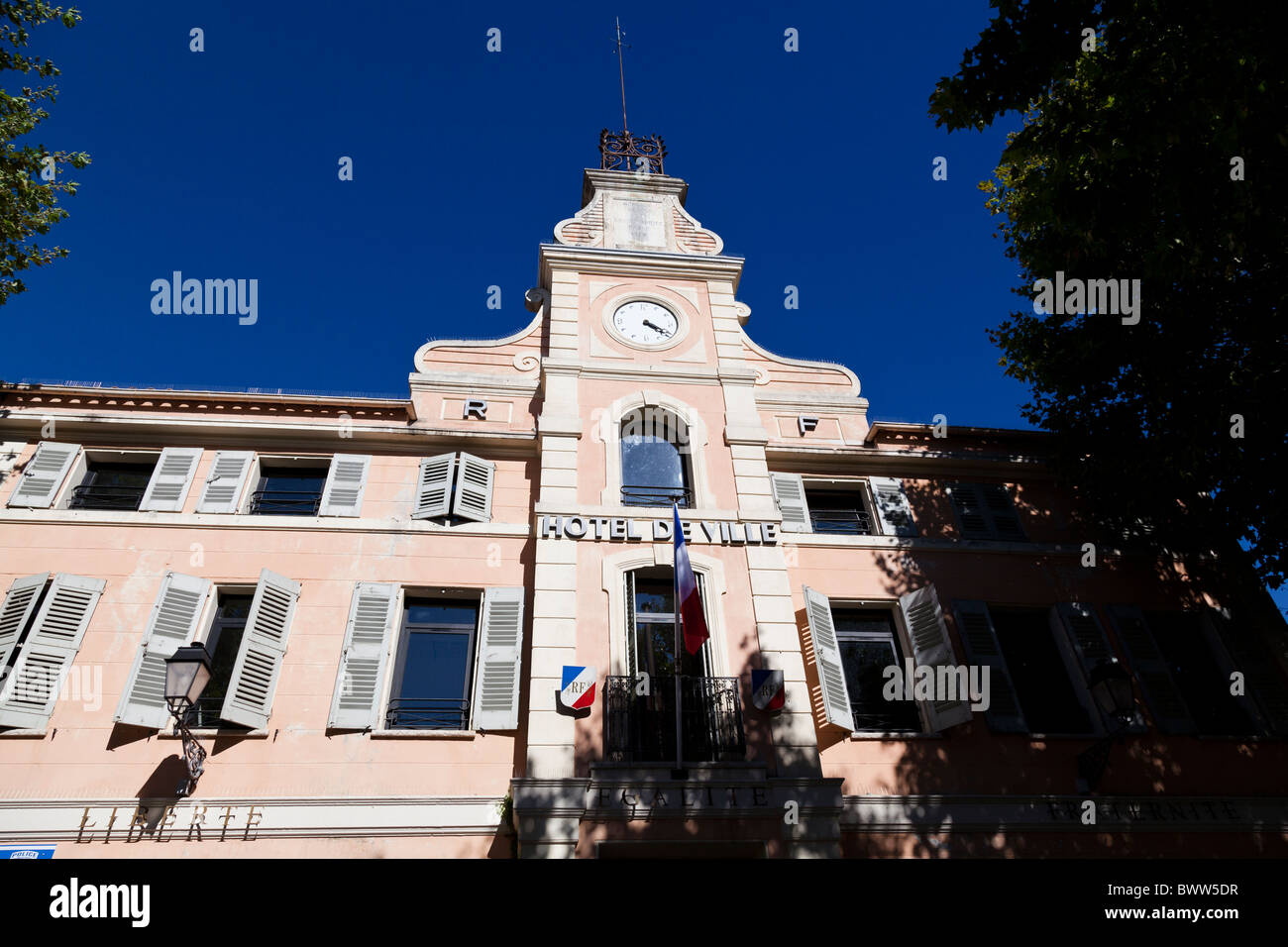 A brilliant blue sky contrasts with the pink of the Town Hall in
