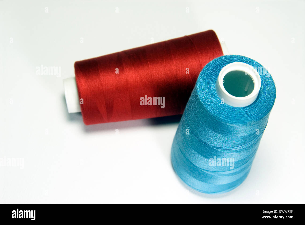 Blue and red thread for sewing or embroidery - sewing supplies. Stock Photo