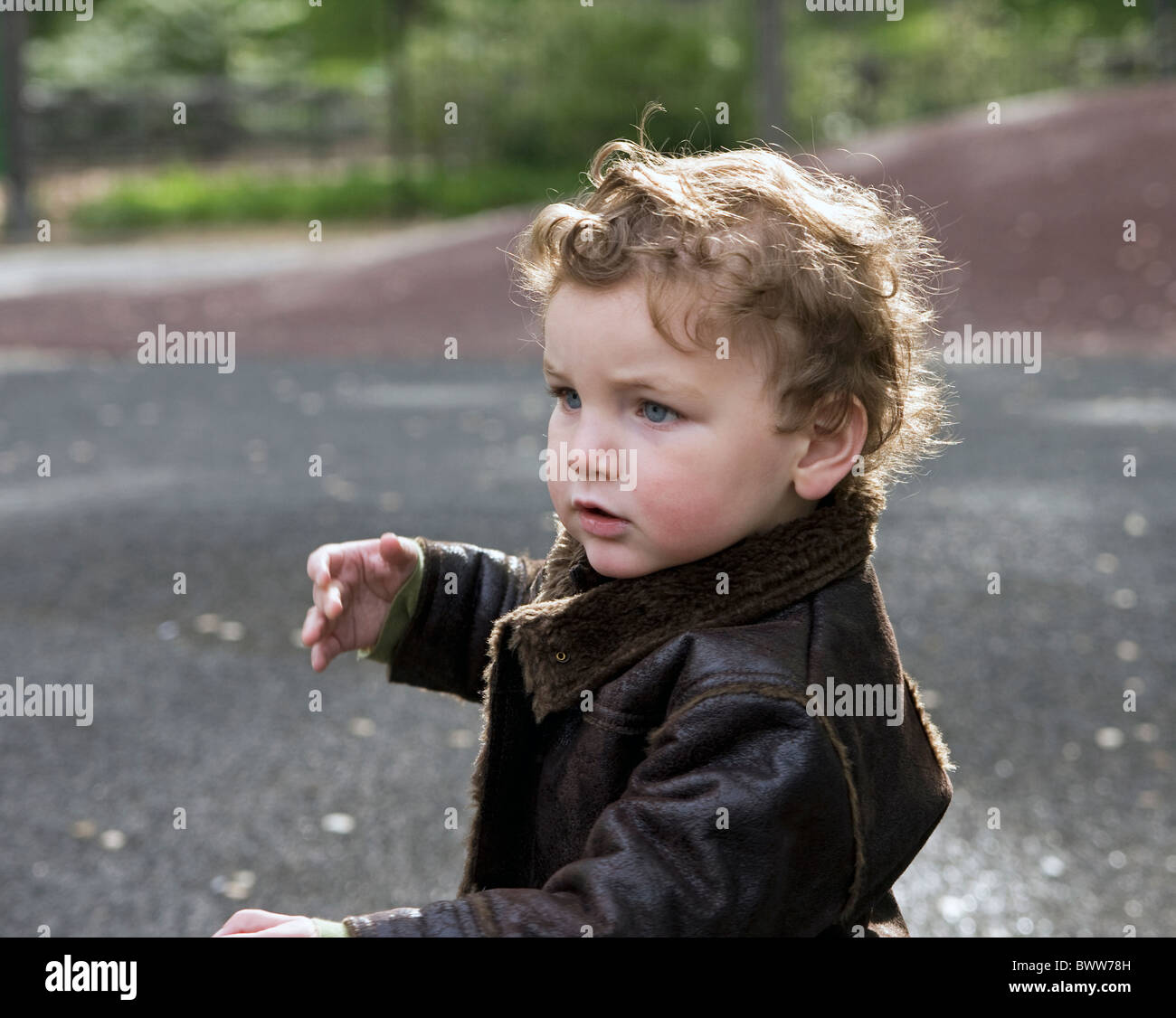 A 2 year old boy enjoys a sunny day in Central Park in New York City. Stock Photo