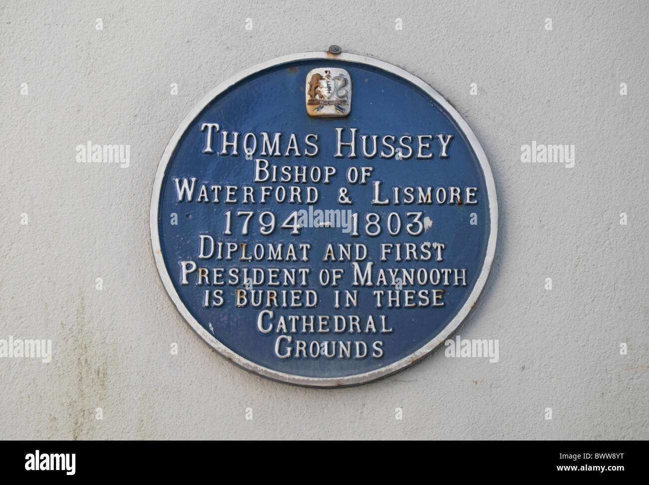 Blue plaque to Bishop Thomas Hussey in the grounds of Waterford Cathedral in Waterford City, Co Waterford, Ireland (Eire). Stock Photo