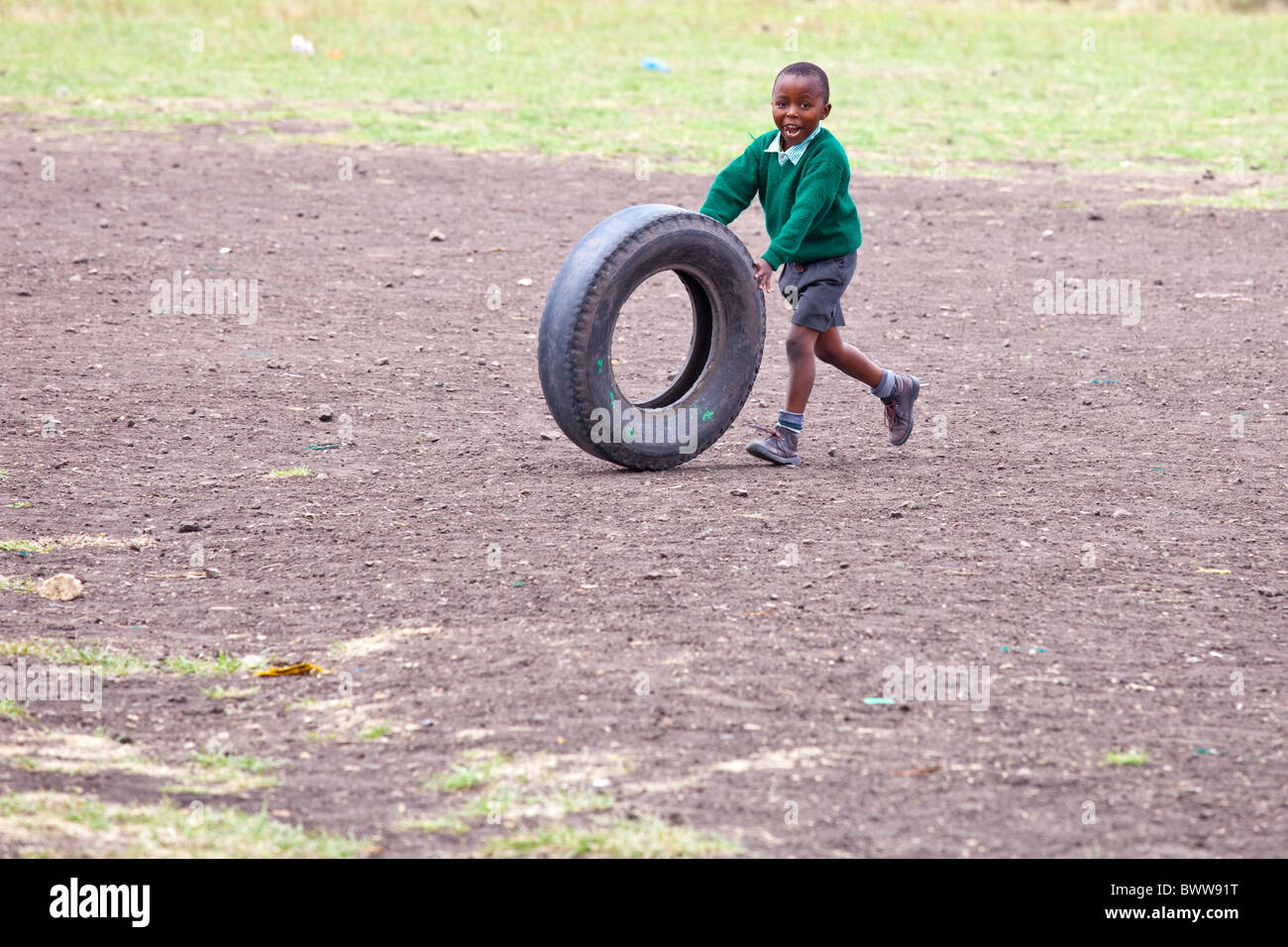 Boy rolling a tire, Maji Mazuri Centre and School, Nairobi, Kenya Stock Photo