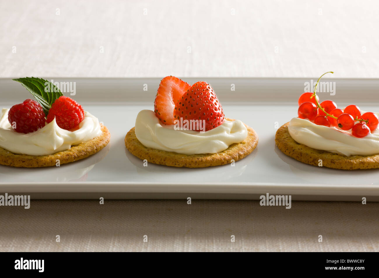 Crackers with Creamy Cheese spread, garnished with Raspberries, Mint