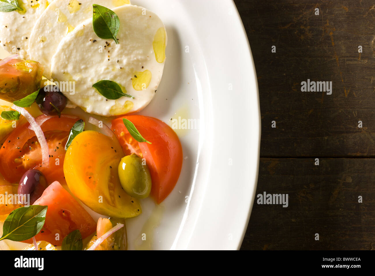 Mozzarella with Tomato and Olive variety, Olive Oil and Fresh Oregano Stock Photo