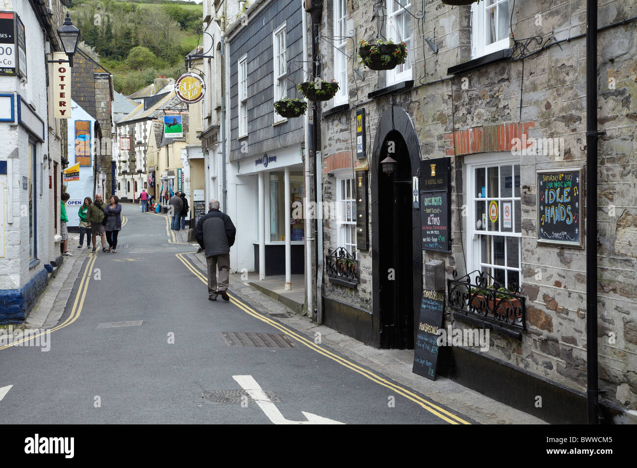 The Ship Inn and Narrow main street through Mevagissey, Cornwall, England, United Kingdom Stock Photo