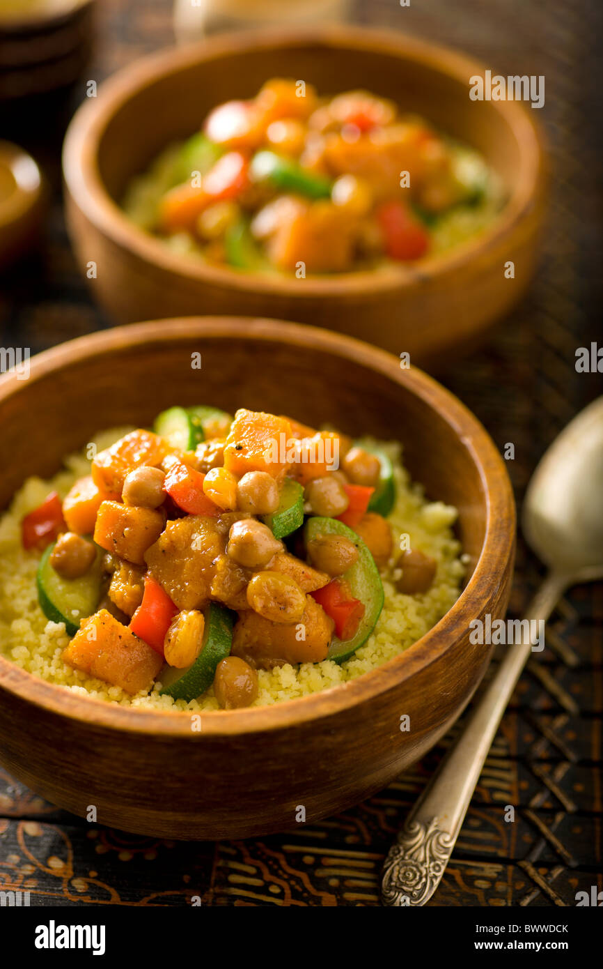 Moroccan Vegetable Stir-Fry with Chickepeas, Garam Masala, Butternut Squash, Zucchine, Raisins, Red Bell Pepper and Cous Cous Stock Photo