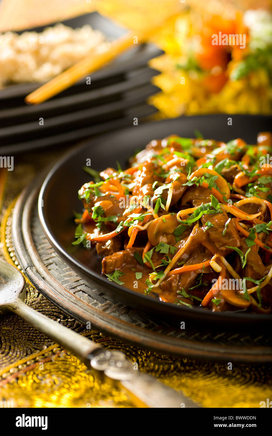 Thai Coconut Beef Stir-Fry with carrot, mushroom, and bean sprouts Stock Photo