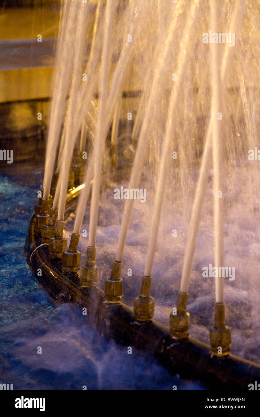 A circle of individual water jets unite to form a fountain Stock Photo