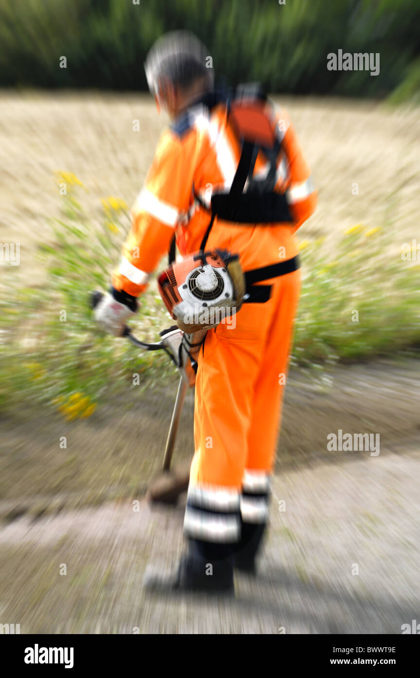 Road worker with grass cutters Stock Photo