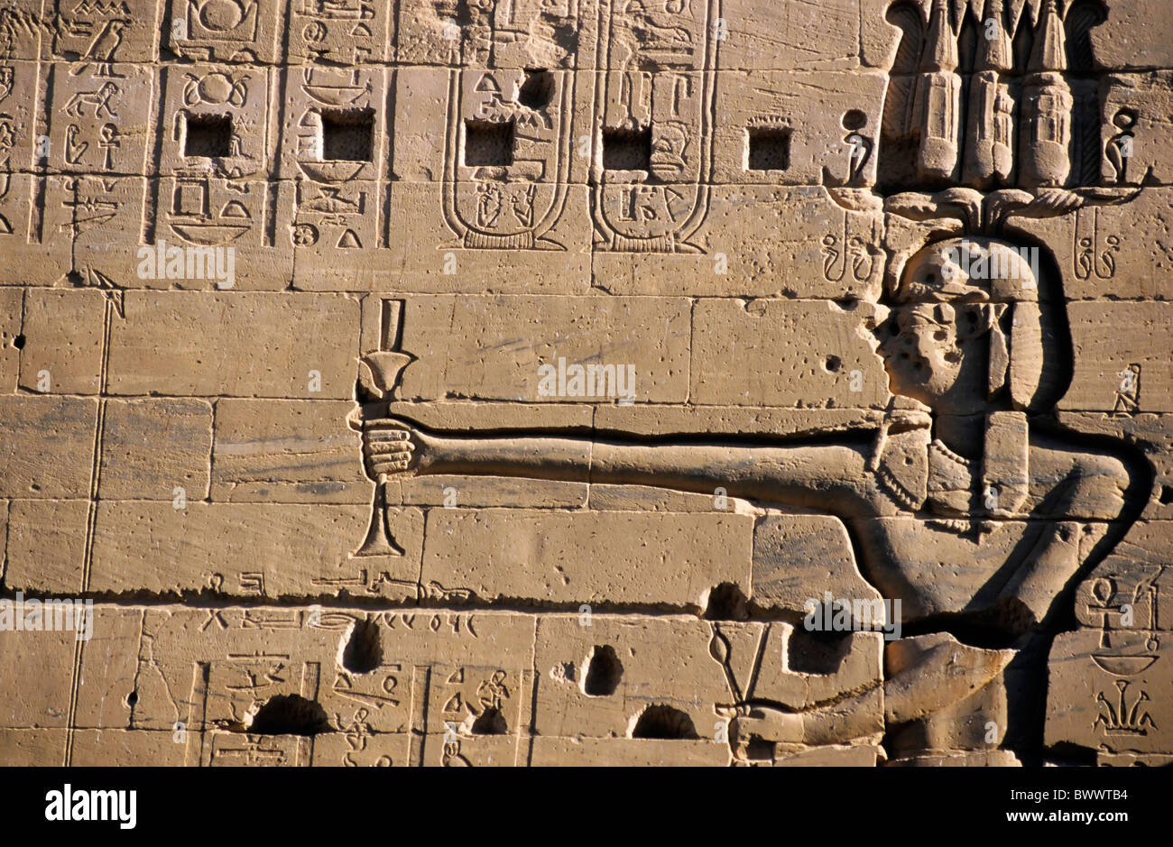Detail of a carved stone wall at the ancient temple for Isis on the island of Philae on the Nile river, Egypt. Stock Photo