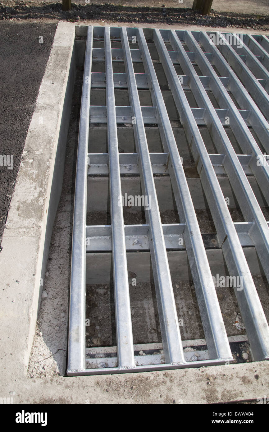 Close-up new cattle grid road with ramps allow Stock Photo - Alamy