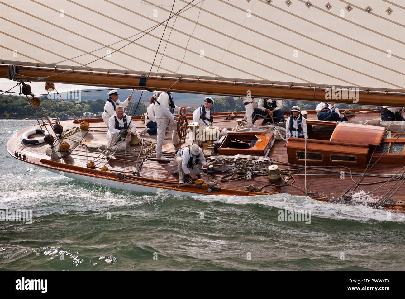 Skipper and crew aboard a classic sailing yacht Stock Photo Alamy