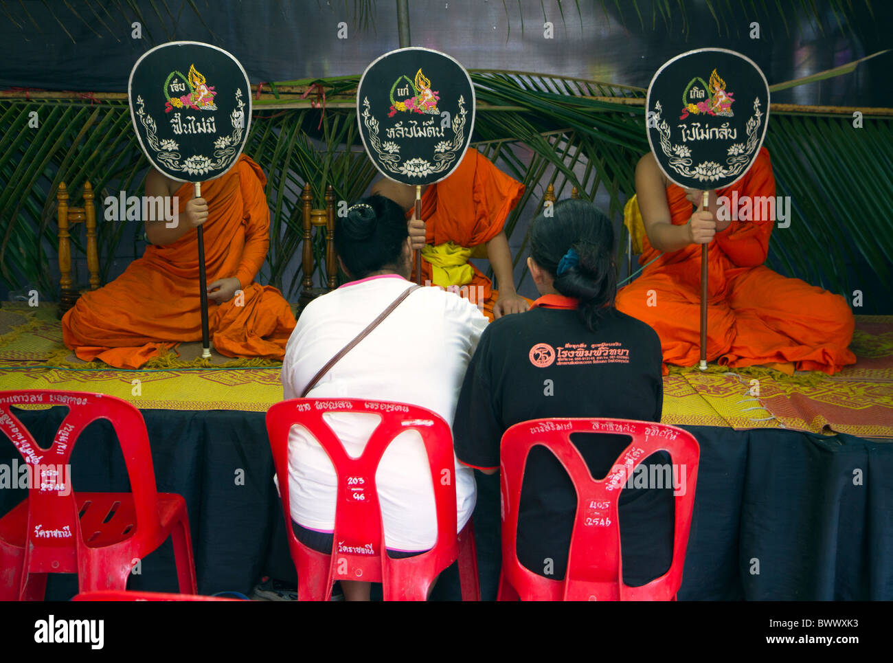 Thai Buddhist monks at a funeral ceremony using talaptr fans in Sukhothai, Thailand Stock Photo