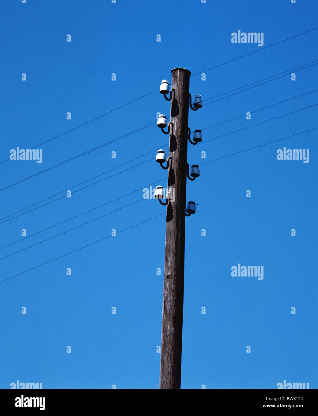 energy sky poles upper part section power supply lines wires stream current masts poles Stock Photo
