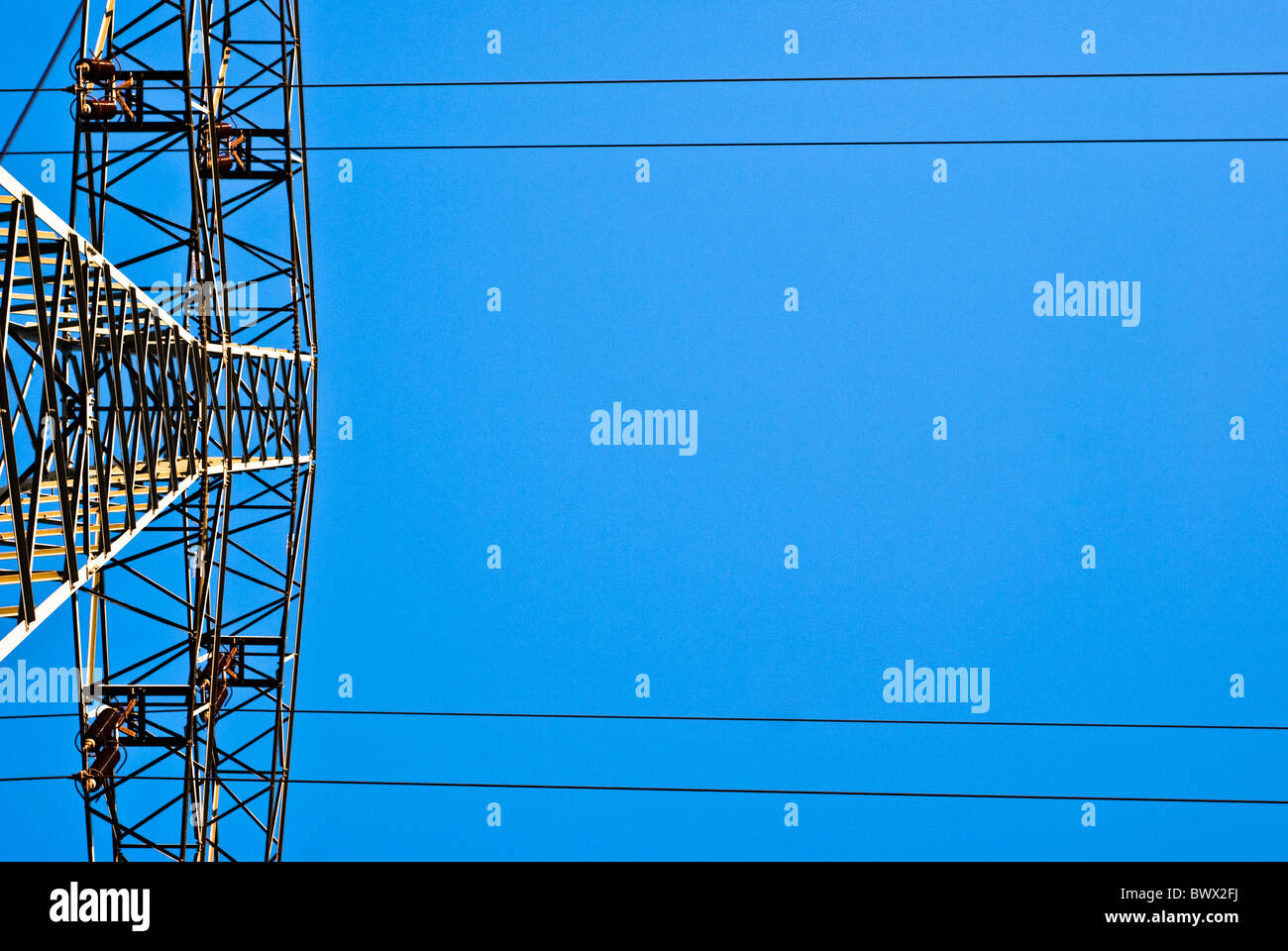 large electricity pylon against blue sky Stock Photo - Alamy