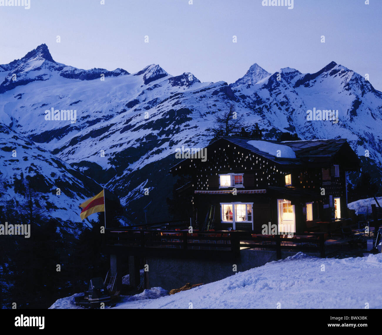 evening alp hut outside hut mountains alpine Alps lighting chalet mountains Switzerland Europe terrace Stock Photo