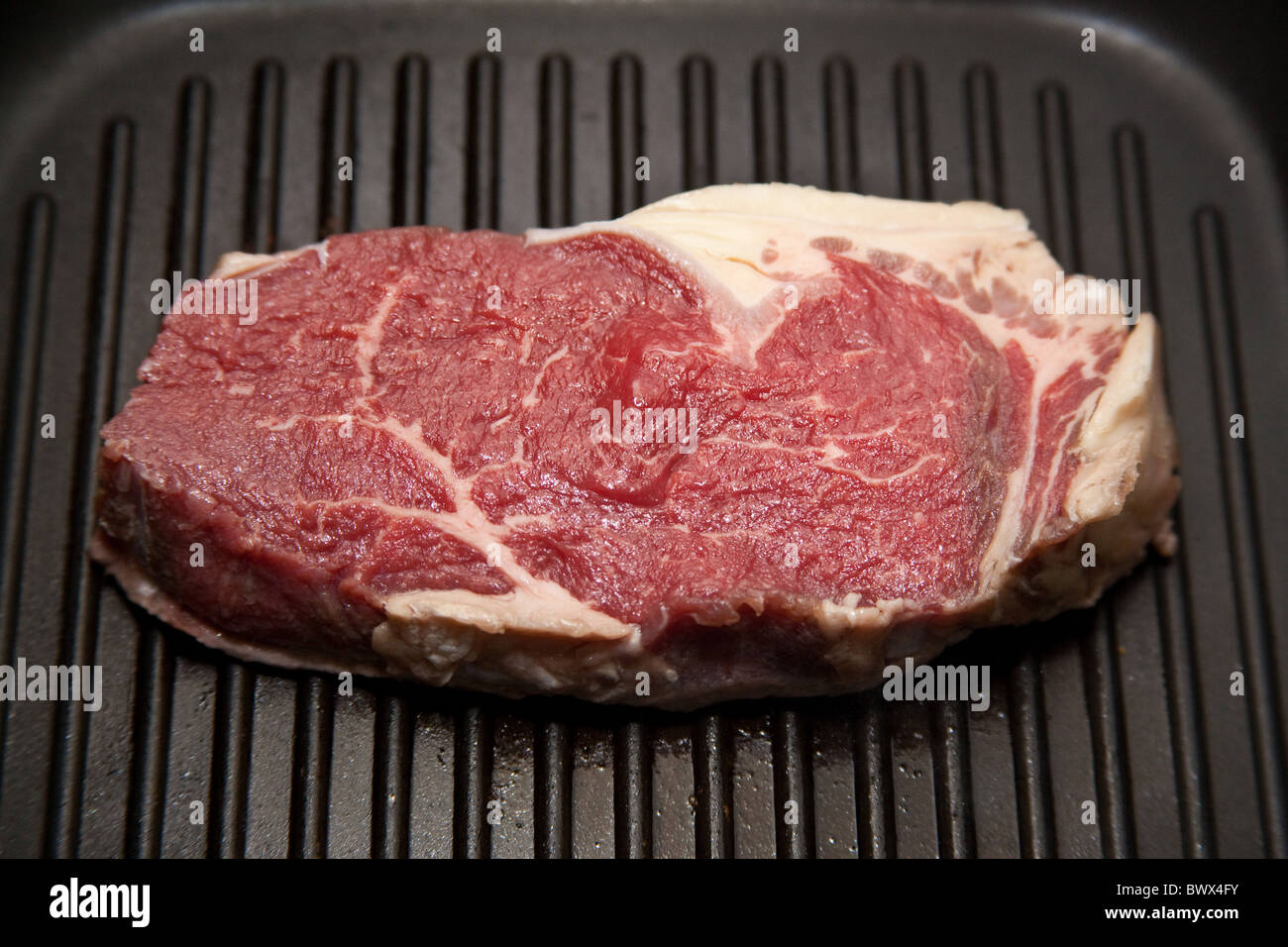 Rump steak being cooked in a griddle pan Stock Photo Alamy