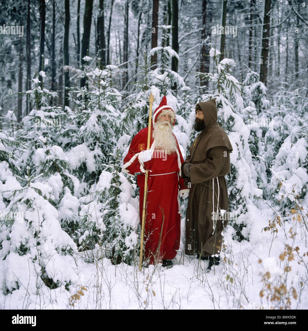 Santa Claus outside farm-hand servant Ruprecht Schmutzli snow Saint Niklaus wood forest winter snow Stock Photo