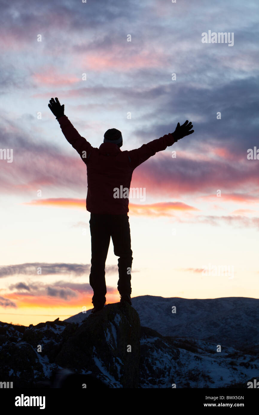 A man on Loughrigg at Sunset above Ambleside, Lake District, UK. Stock Photo