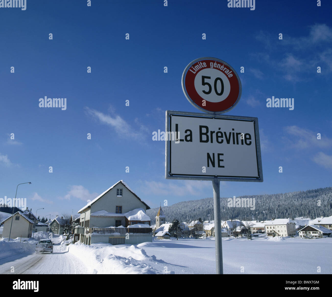 houses homes La Brevine country road street canton Neuenburg Neuenburg Jura sign snow Switzerland Europe Stock Photo