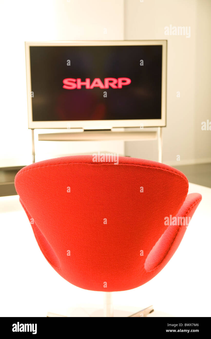 High quality widescreen LCD TV and comfortable red armchair Stock Photo