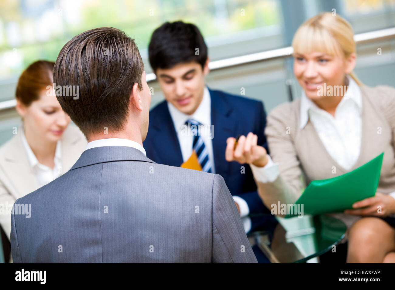 Rear view of businessman during interview with partners Stock Photo - Alamy