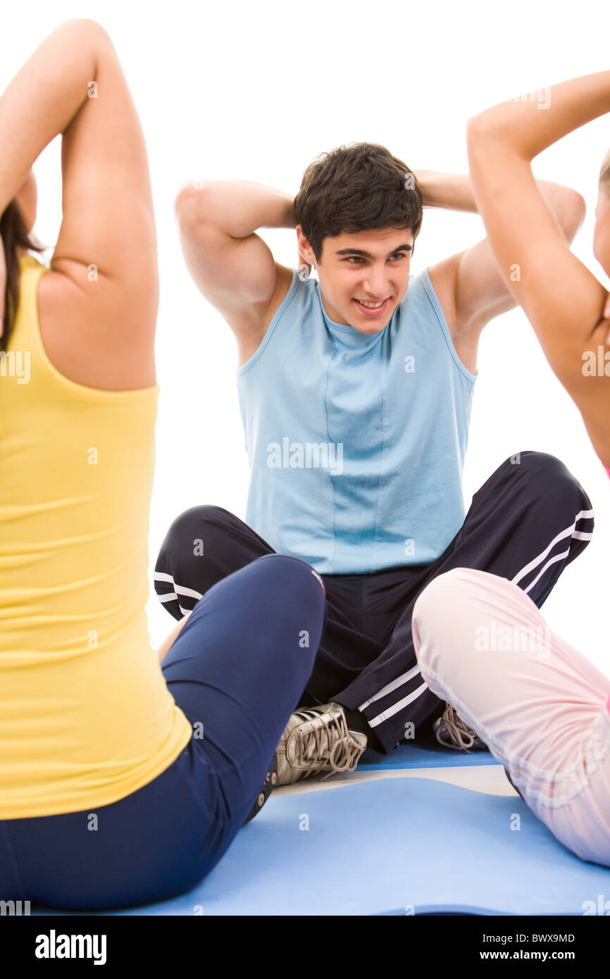 Portrait of young male instructor showing physical exercise to girls Stock Photo