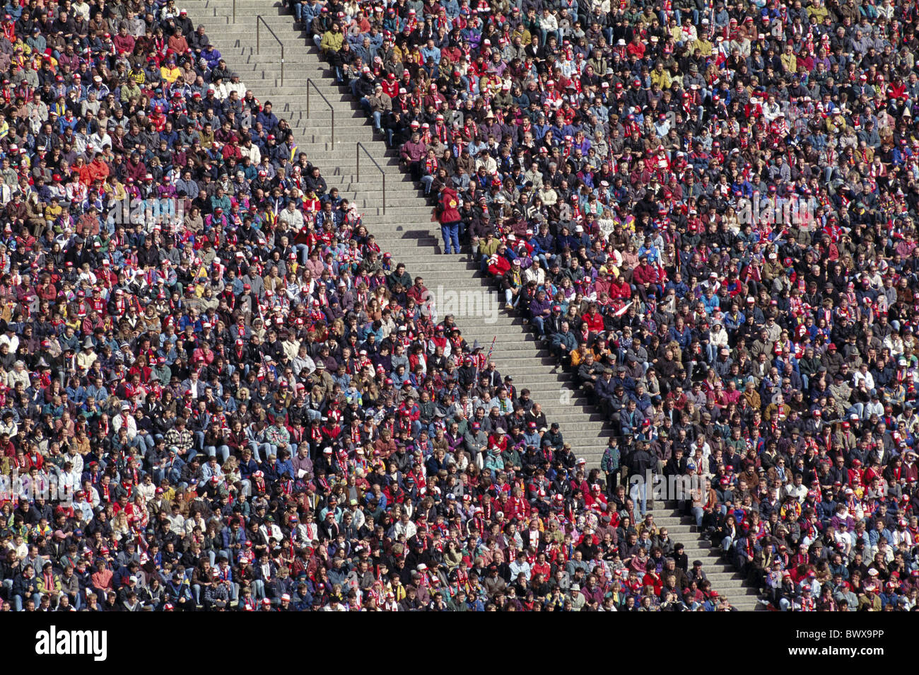 bright colours fans football stadium mass Munich Bavaria Germany Europe ...