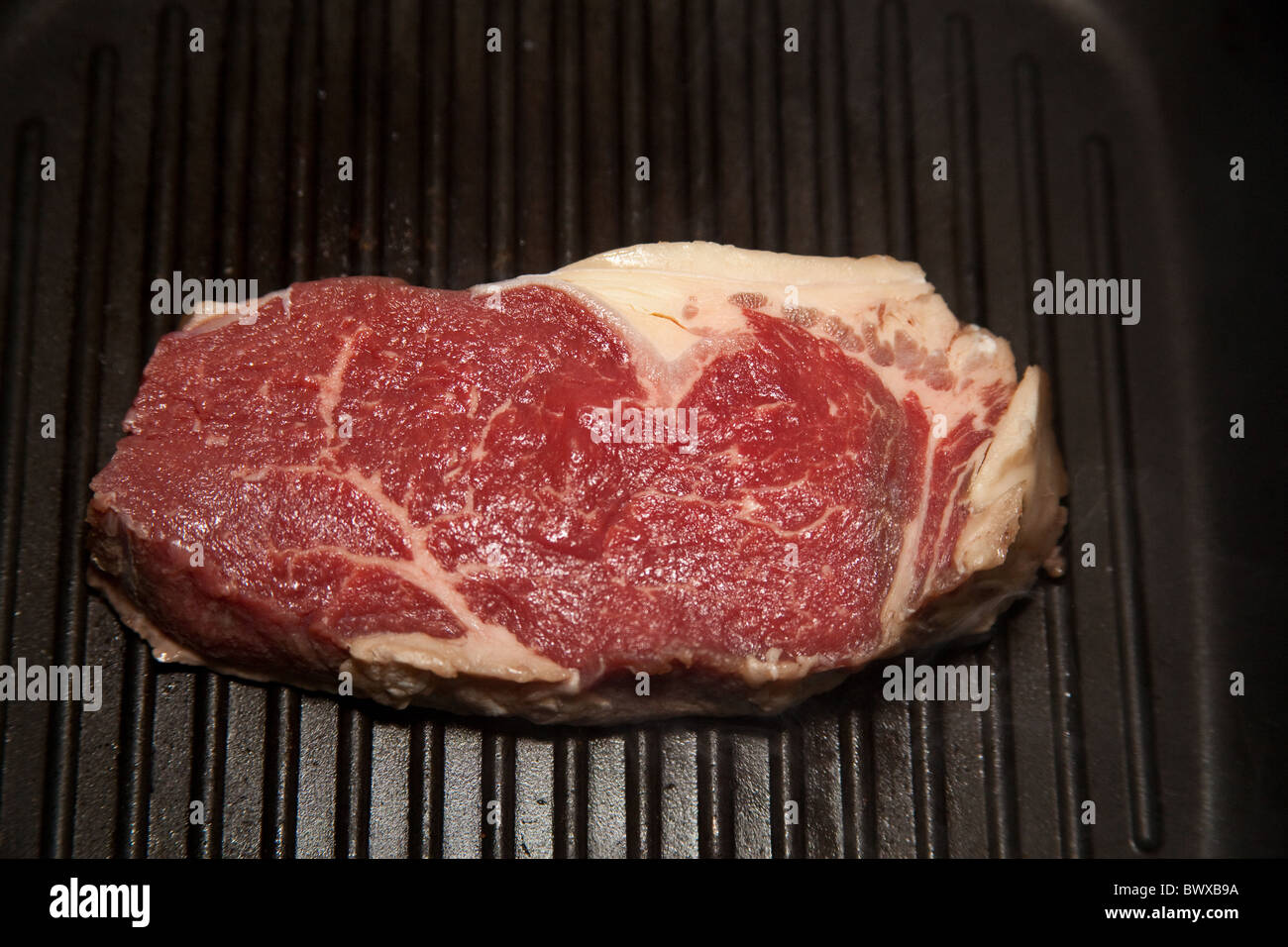 Rump steak being cooked in a griddle pan Stock Photo Alamy