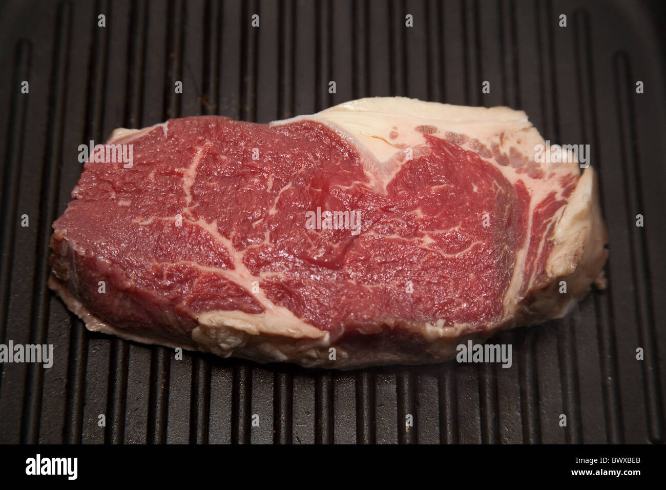 Rump steak being cooked in a griddle pan Stock Photo Alamy