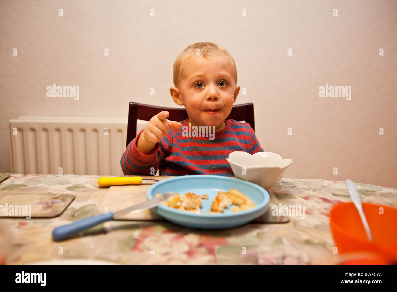 Young boy (18 month old) eating at the table, Sheffield, England, United KIngdom Stock Photo Alamy