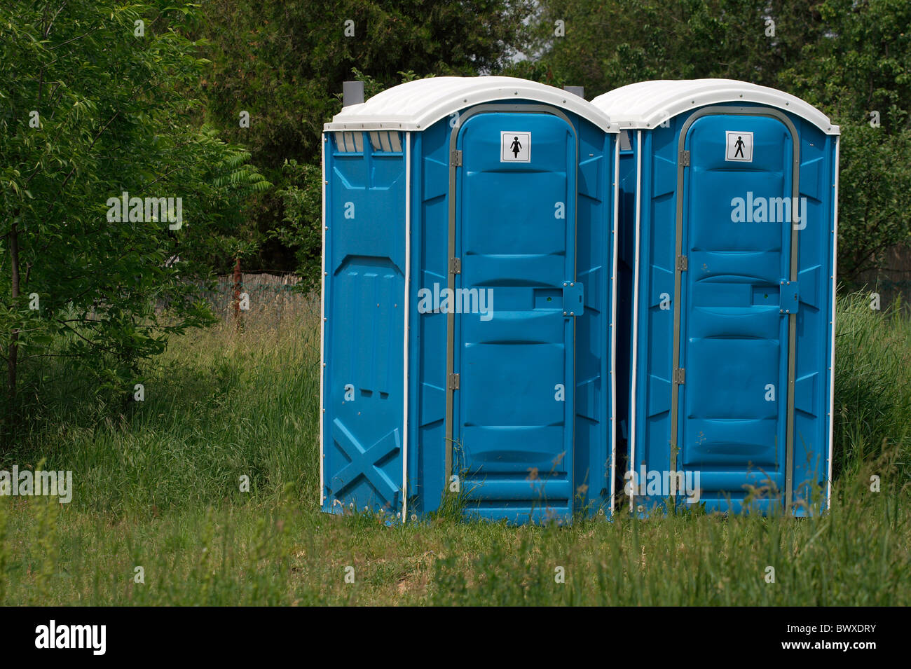 Blue mobile toilet cabins in an outdoor scene Stock Photo