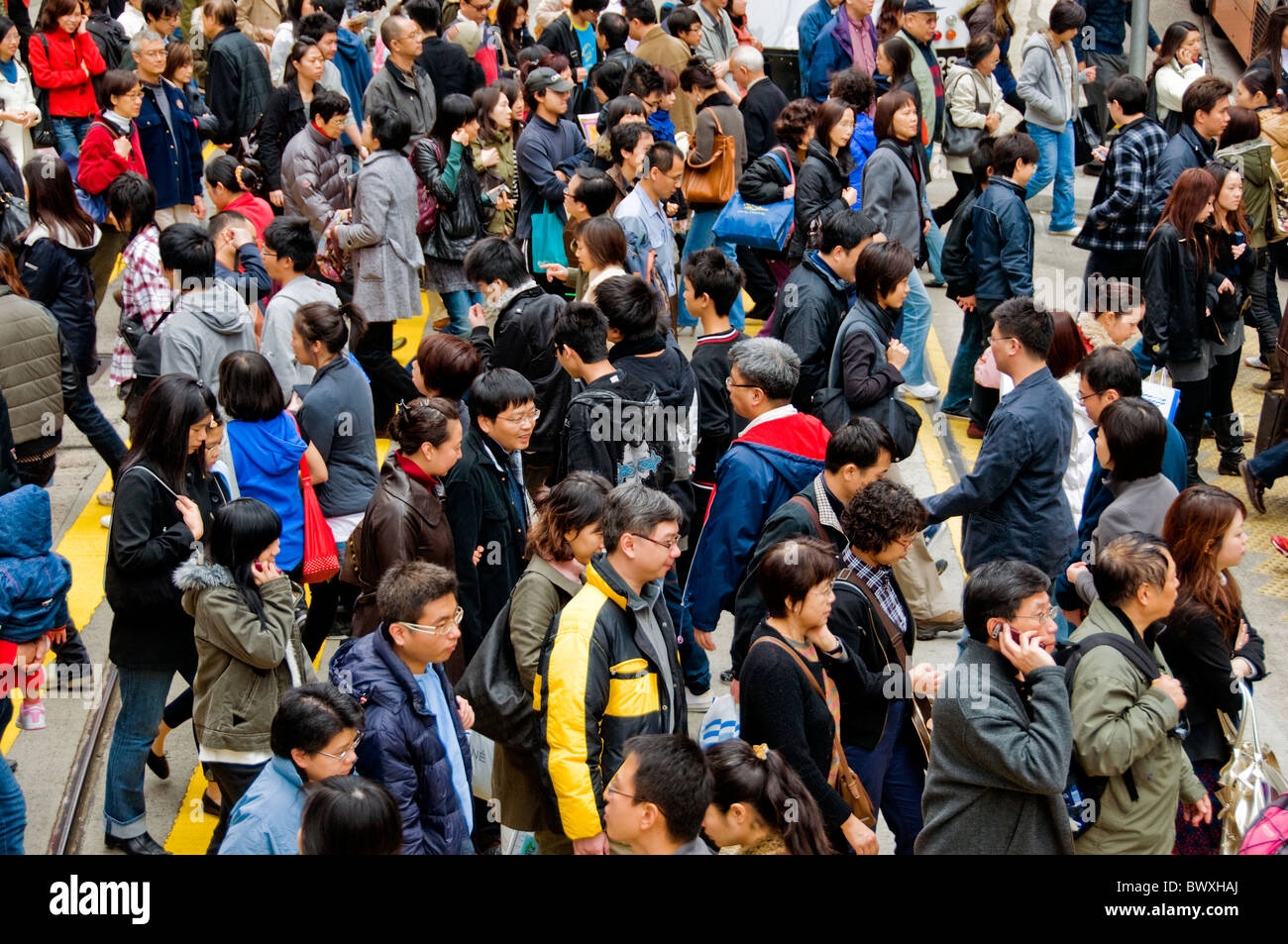 Crowd of people walking in downtown Hong Kong China Stock Photo