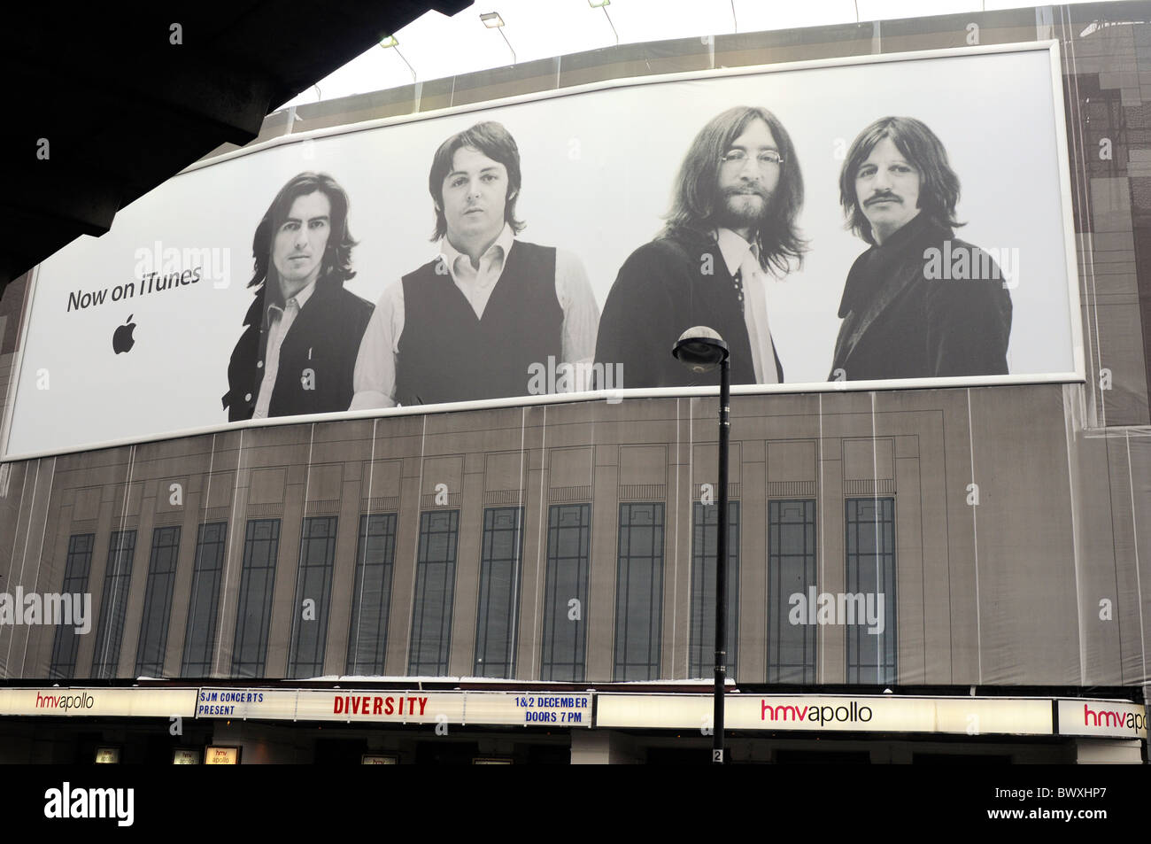 Giant iTunes posters of The Beatles hang on the HMV Apollo, London ...