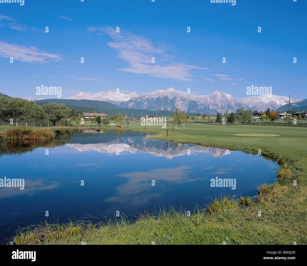 golf sport arrangements enclosures mountains lake sea reflection Austria Europe Tyrol Seefeld golf course Stock Photo
