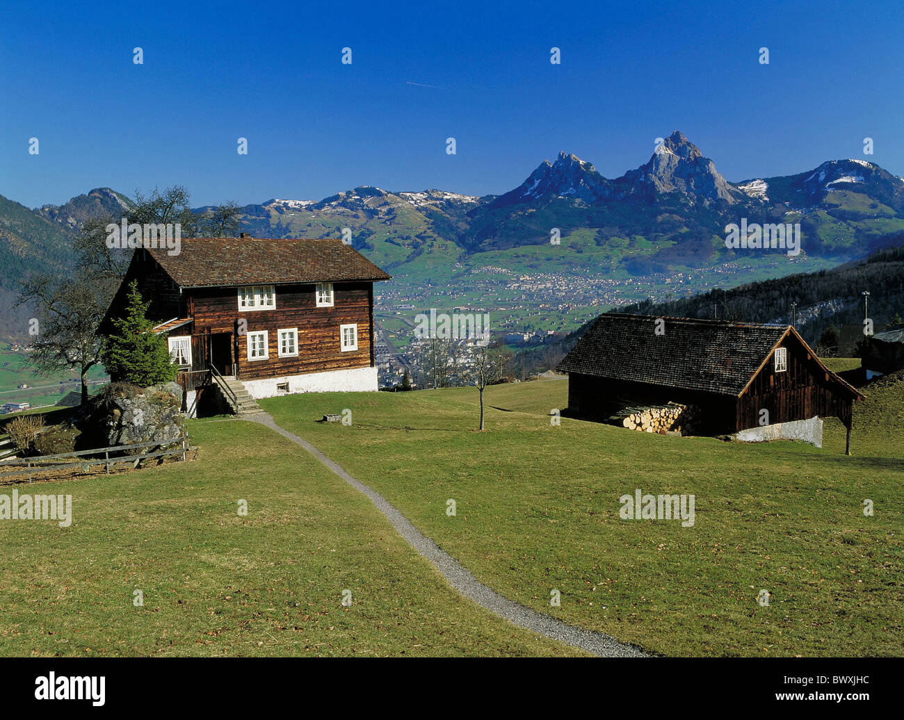 look glance on big great and small little myths houses homes Switzerland Europe Schwyz mountain Seelis Stock Photo