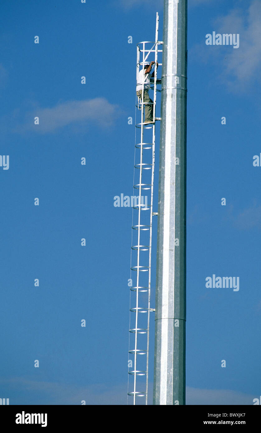 technology technics occupations professions engineers technicians workers mast pole leader ladder high clim Stock Photo