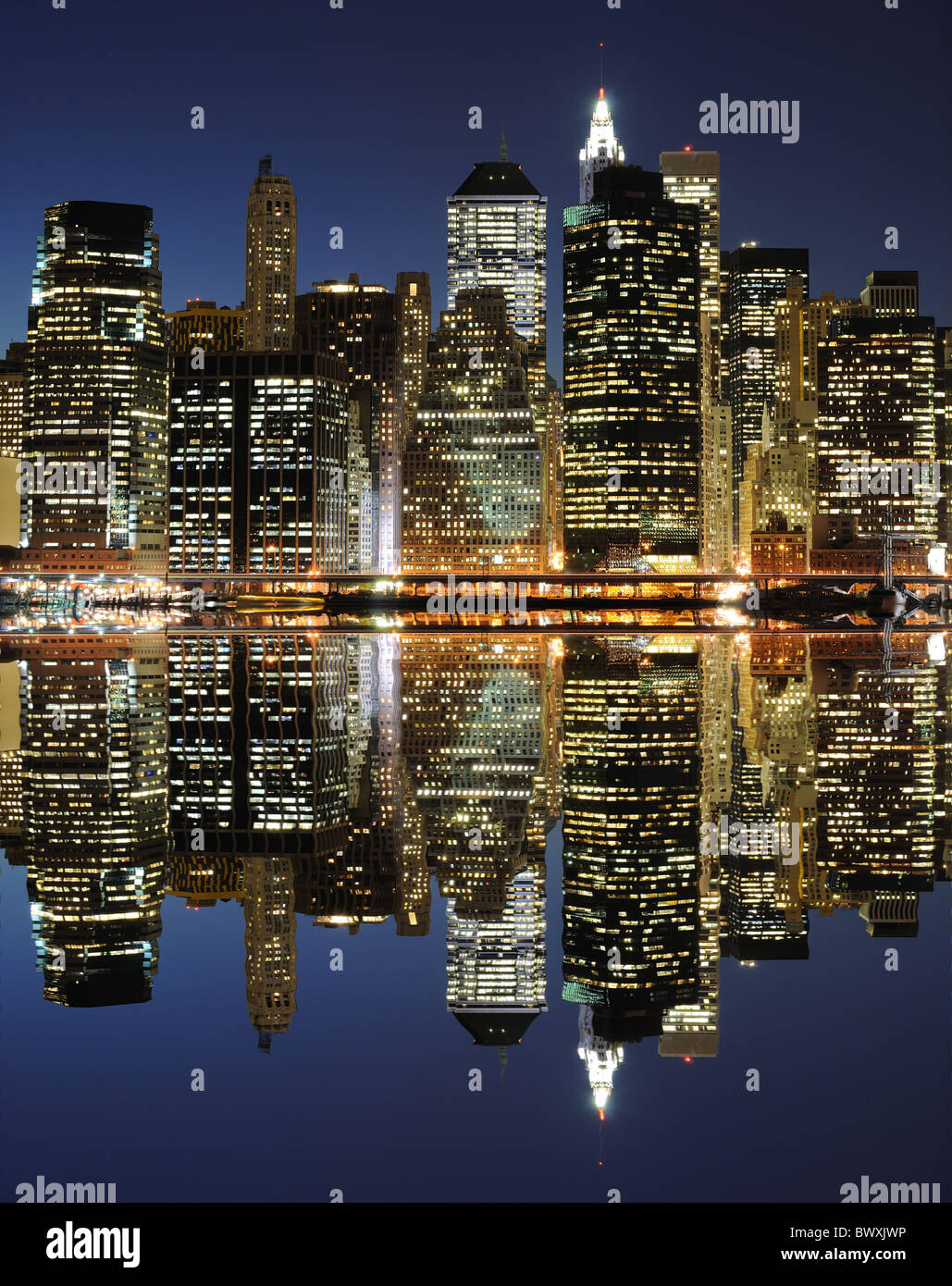 New York City landmark skyline at night with river reflections Stock ...