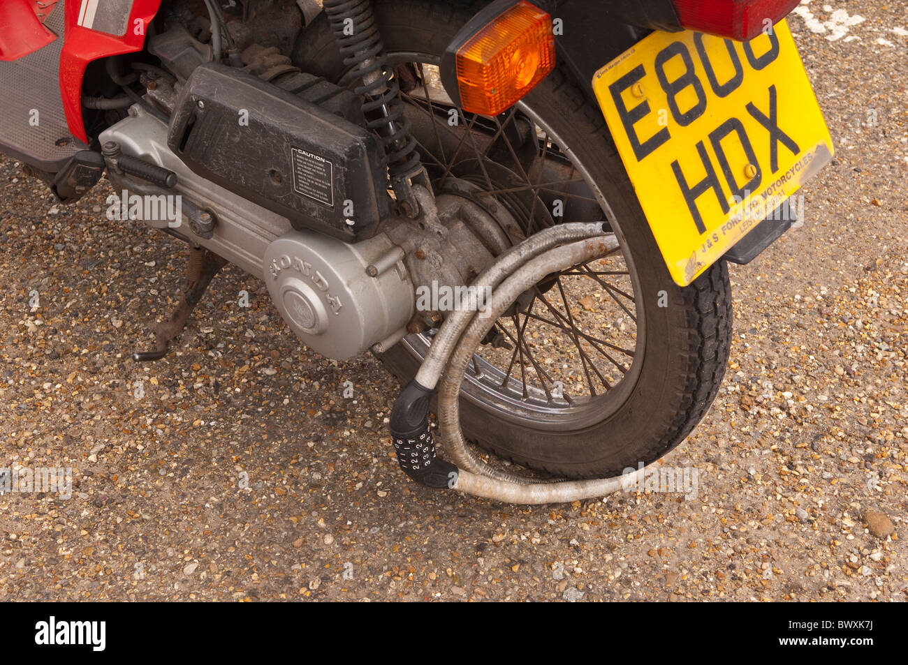 A close up of a combination lock on a moped wheel in the Uk Stock Photo Alamy