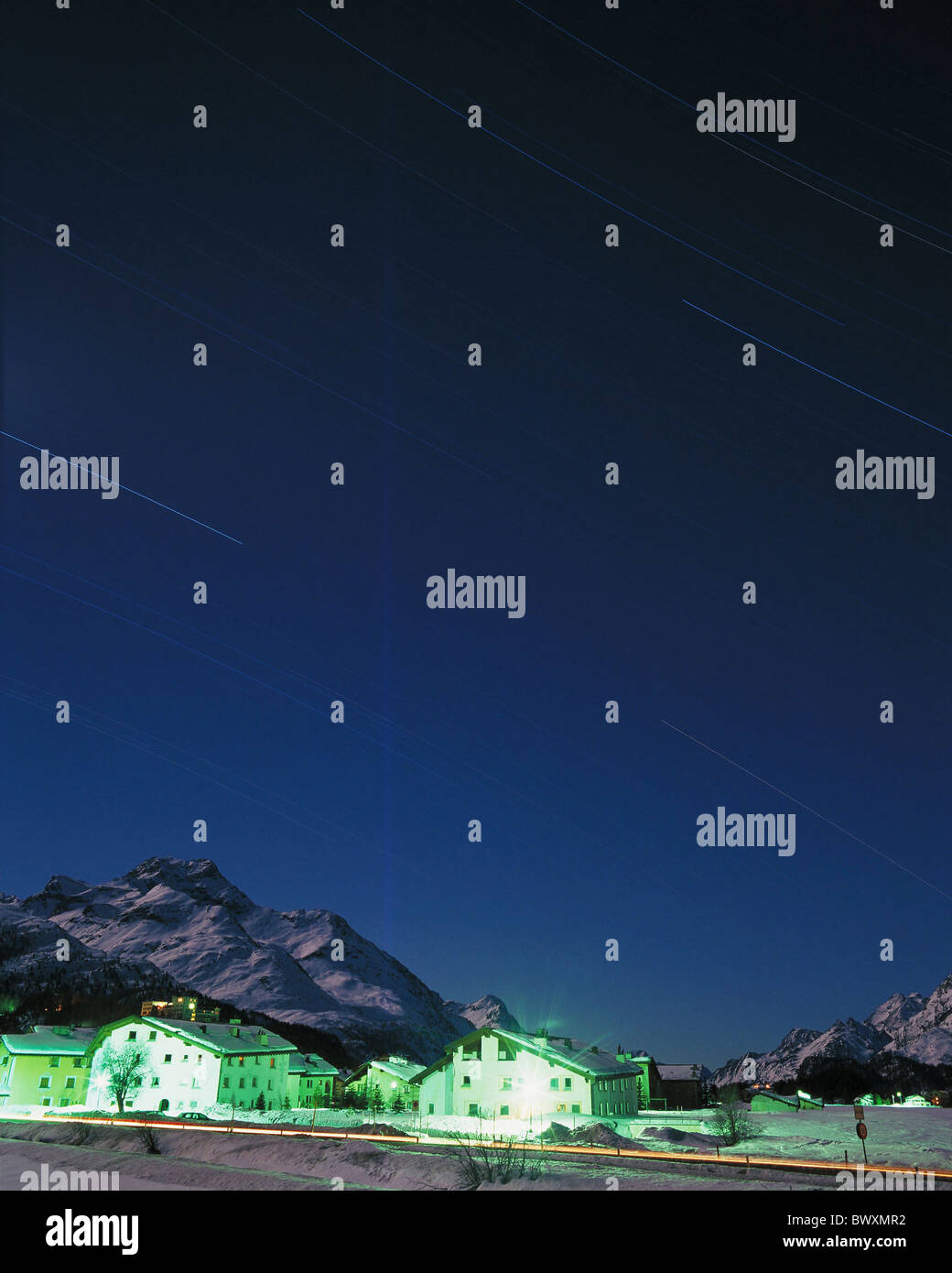 illuminated 10390500 mountains Graubunden Grisons houses homes night skies winter snow night mountains alpine Alp Stock Photo