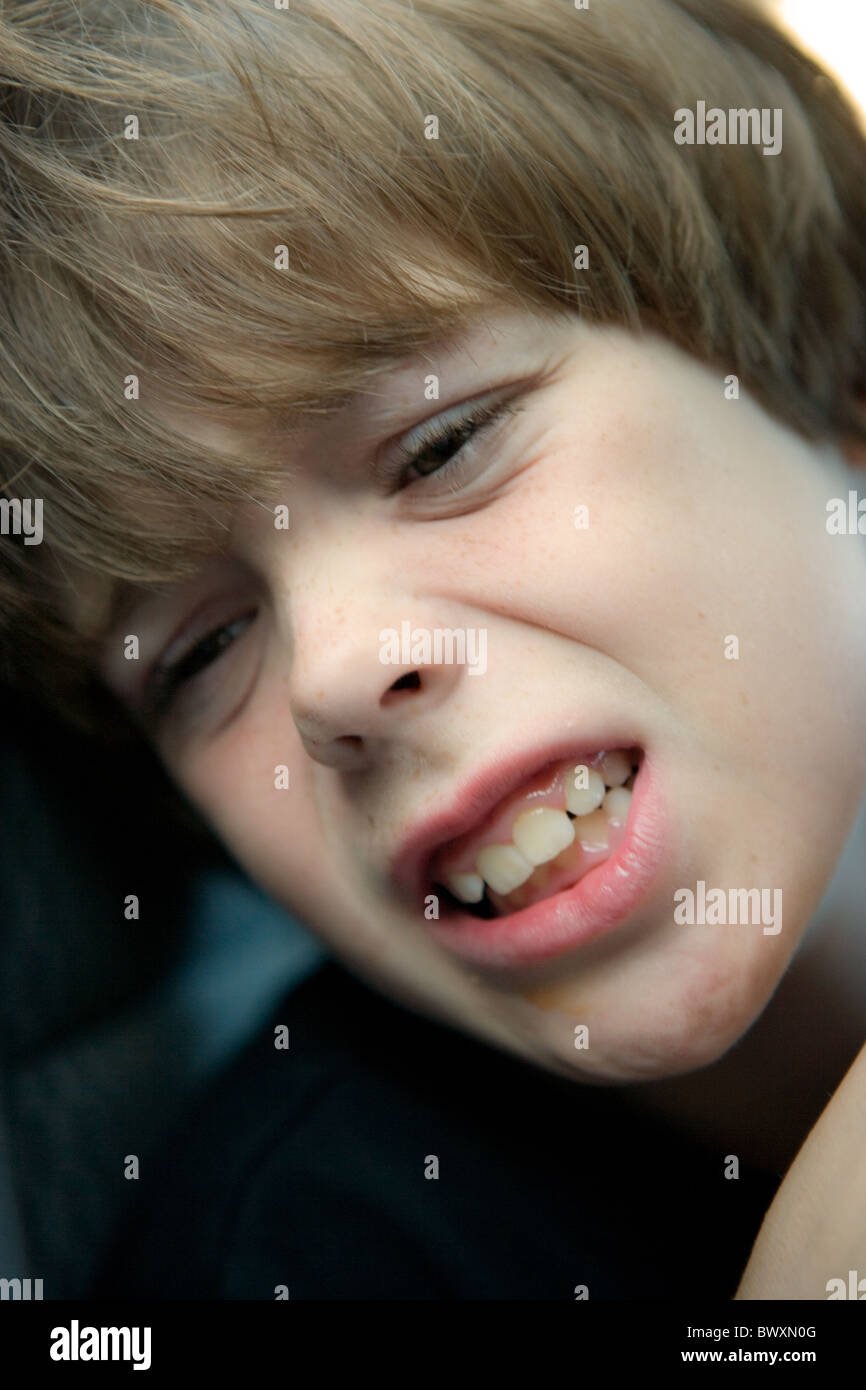 Close up of eight year old boy with pained expression Stock Photo Alamy