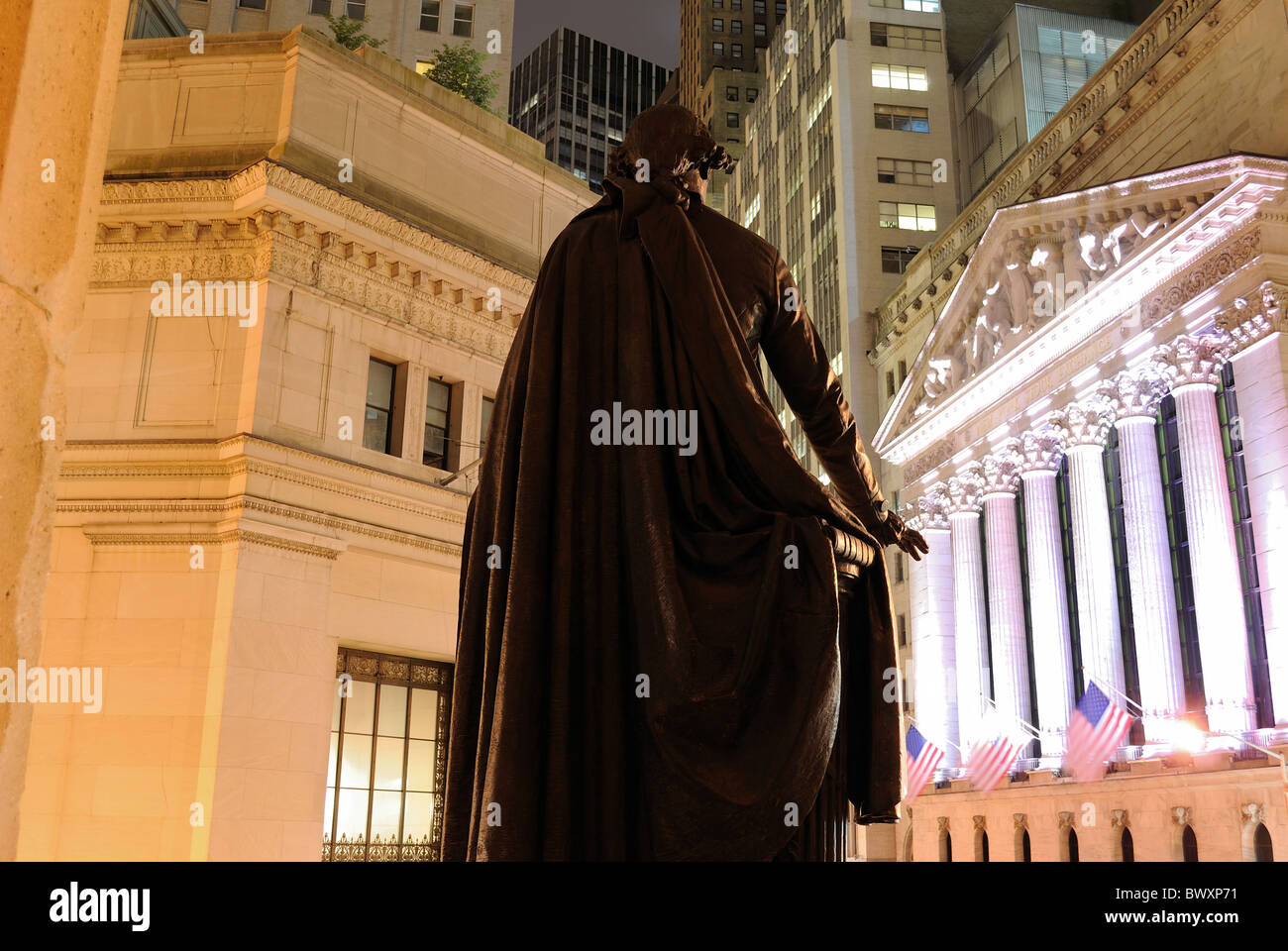 Wall Street in Lower Manhattan viewed from behind the George Washington statue at Federal Hall in New York, New York, USA. Stock Photo