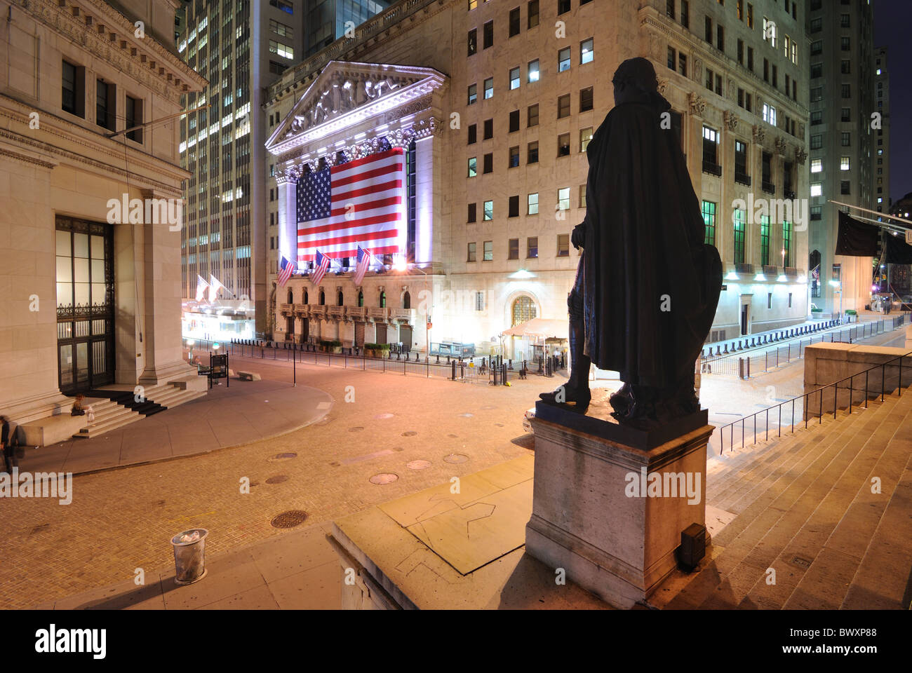 Wall Street in Lower Manhattan viewed from behind the George Washington statue at Federal Hall in New York, New York, USA. Stock Photo
